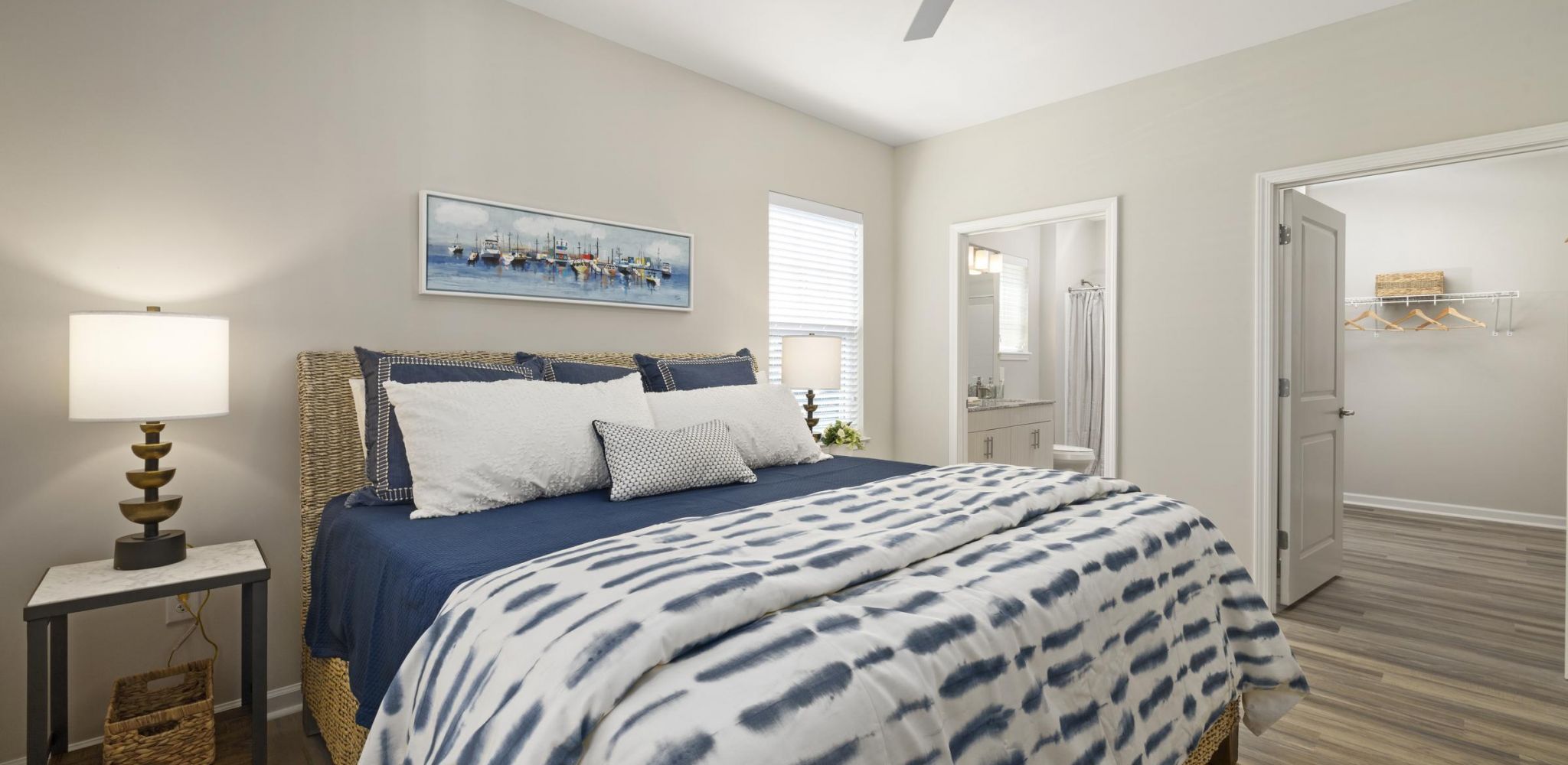 Hudson at Carolina ColoursA cozy bedroom featuring a ceiling fan above a neatly made bed